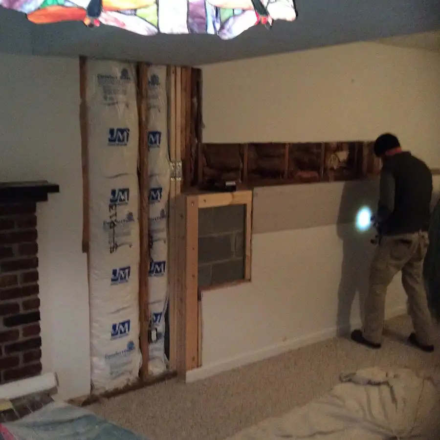 Restoration technician inspecting water damage in Waco